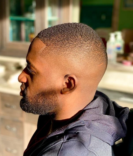 A short faded haircut of a man from the side